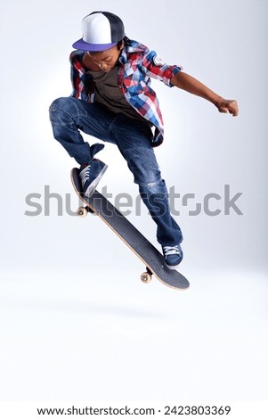 Skateboard trick, jump or African kid in studio with trendy fashion, skill or mockup space with cool style. Skater, performance or young child skateboarding with energy isolated on white background
