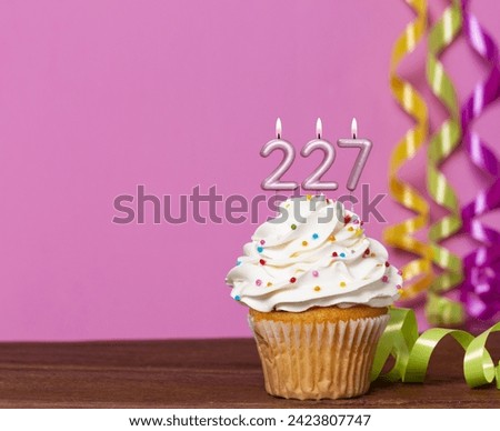Birthday Cake With Candle Number 227 - On Pink Background.