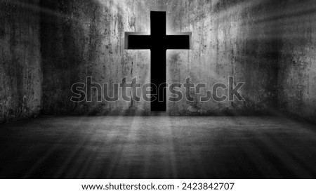 Black cross-shaped entrance with the figure of Jesus Christ glowing on a grunge background in a dark and dim empty room. Black doorway, The concept of in the darkness, light guides the way.
