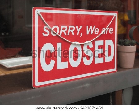 sorry we are closed sign in a store shop window