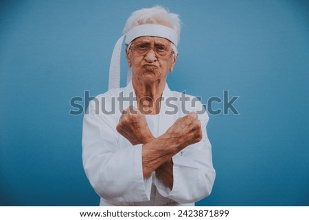 Funny grandmother portraits.granny fashion model on colored backgrounds. Karate master practicing martial arts Royalty-Free Stock Photo #2423871899