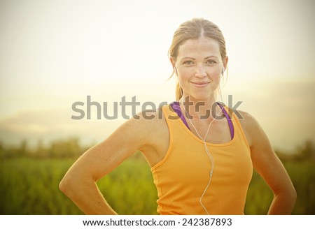 Smiling Female Jogger at Sunset (intentional sun glare)