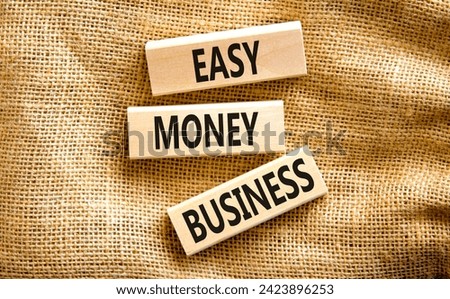 Easy money business symbol. Concept words Easy money business on beautiful wooden blocks. Beautiful canvas table canvas background. Easy money business concept. Copy space.