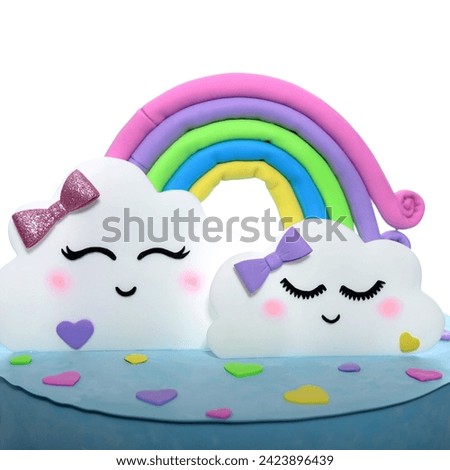 A cake made of paper, soft cardboard similar to a real sweet cake, suitable for birthday parties. The theme features a rainbow and some clouds. The cakes maked of wafer paper, hand made