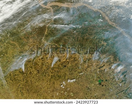 Fires across Central Russia. Fires across Central Russia. Elements of this image furnished by NASA. Royalty-Free Stock Photo #2423927723