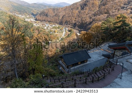 High-angle view of valley, village and Buddhist temple in autumn