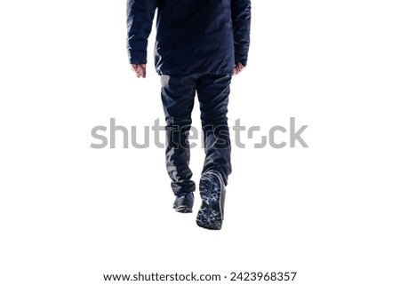 isolated photo of a man walking in winter clothes