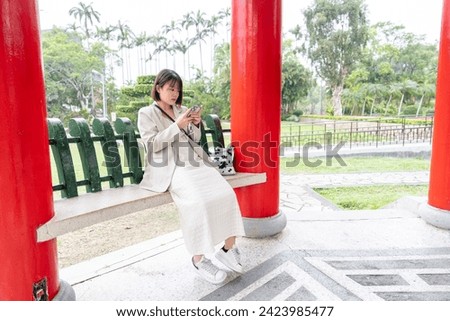 A young Taiwanese woman in her 20s taking a walk in a big park in Shilin District, Taipei City, Taiwan