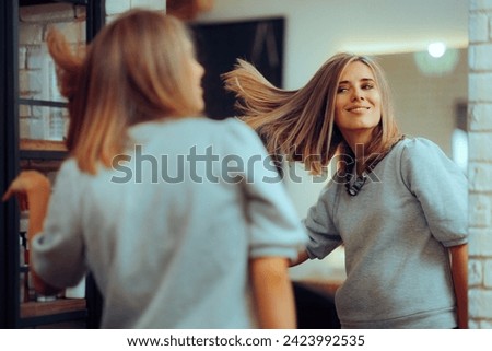 
Beauty Salon Customer Admiring her Hair Style in the Mirror. Happy woman loving her new colored coiffure 
 Royalty-Free Stock Photo #2423992535
