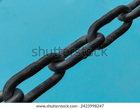 Interlocked Perspectives: The Intimacy of Chain Link Fences. Against blue water surface as background.