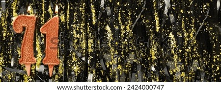 Burning red birthday candles on glitter tinsel background, number 71. Banner. Copy space