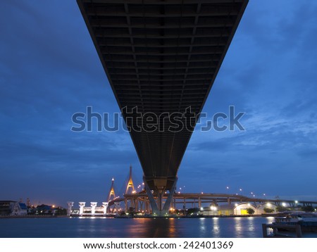 cable stayed bridge cross river over head in twilight