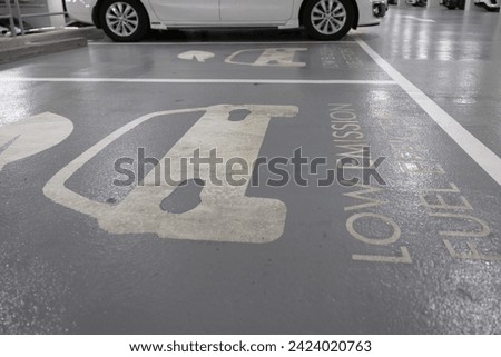low emission fuel efficient parking lot. reserve parling for low emission fuel or ev car sign on parking lot.