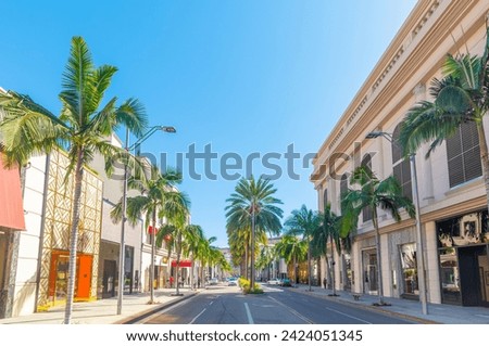 Luxury stores and palm trees in world famous Rodeo Drive in Beverly Hills. Los Angeles, California, USA Royalty-Free Stock Photo #2424051345
