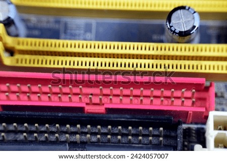 A closeup of a computer main board electronic motherboard, the main printed circuit board (PCB) in general-purpose computers and other expandable systems, allows communication of electronic components Royalty-Free Stock Photo #2424057007