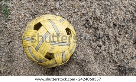 Top view of takraw ball on the sand surface.