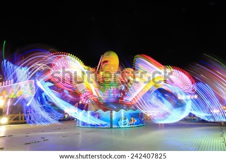 Abstract blurry light background with long exposure picture of a carrusel rotating during the christmas fair in Alicante, Spain