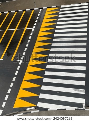 Pedestrian crossing, zebra. Alternating yellow and white lines. Designation of the place of the permitted street crossing. Road crossings marking. 