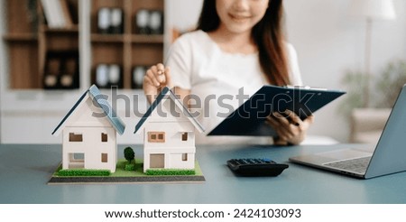 Considering buying a home, investing in real estate. Broker signs a sales agreement. agent, lease agreement, successful deal . asian woman