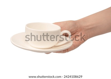 Female hand holding coffee cup and saucer isolated on a white background.  Royalty-Free Stock Photo #2424108629