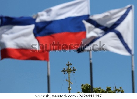 City of Evpatoria (Crimea, Crimean peninsula) Crimean flag, Russian flag, St. Andrew's flag and the cross of the Orthodox Church.