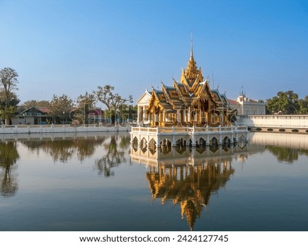 Bang Pa-In Aisawan, artificial lake with bridge and temple in Thipya-Art  at the Royal Summer Palace near Bangkok, Thailand Royalty-Free Stock Photo #2424127745