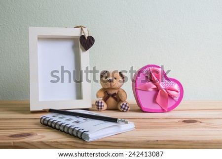 Still life with gift box on wooden table over grunge background, Valentine concept