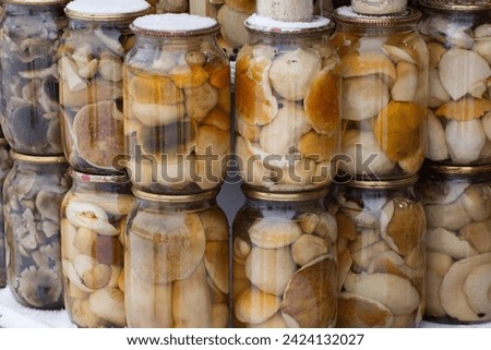 Canned mushrooms in glass jars. Food stocks for the winter.