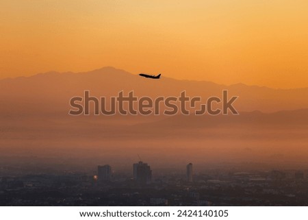 silhoutte airplane fly over landscape of chiang mai city form DOI SUTHEP mountain at morning  Royalty-Free Stock Photo #2424140105