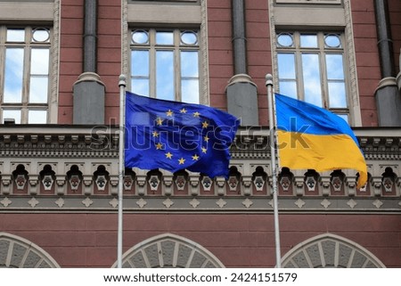 Flags of Ukraine and European Union in Kyiv. State Ukrainian and European Union flags near National Bank, Kiev. European integration of Ukraine