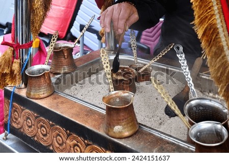Turkish coffee with original handmade copper coffee pot over embers. Street service in Istanbul, Turkey