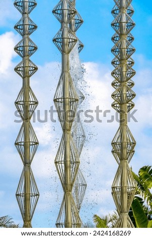 Artistic fountain well with metal figures in a tropical setting in Playa del Carmen Quintana Roo Mexico. Royalty-Free Stock Photo #2424168269