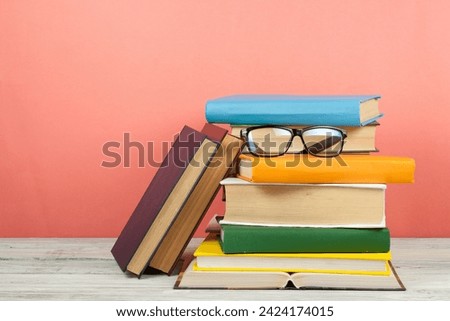 Open book, hardback colorful books on wooden table. Glasses. Back to school. Copy space for text. Education business concept