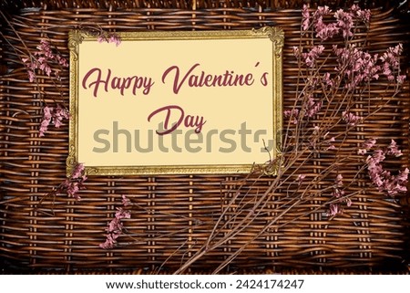 happy valentine's day on golden picture or photo frame mockup with pink baby's breath, gypsophila on esparto halfah background