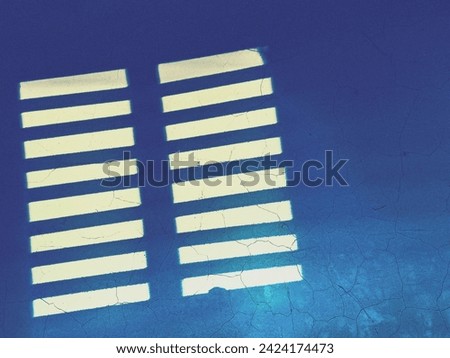 Overlay window light falling on weathered blue wall through window, shadow background