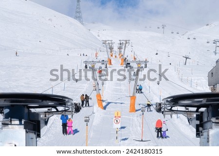 Ski resort. Elevator to the mountain slope. Winter mountain landscape. A place for skiing. High rocks and snow. View of the mountains.