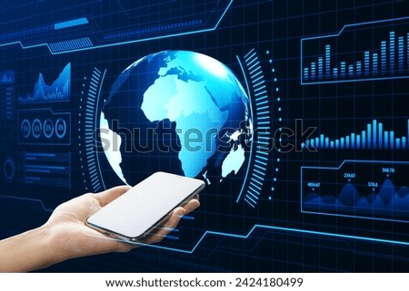 Close up of female hand holding white mock up phone with holographic screen with digital globe interface and business chart on blurry blue background. HUD, international stock and future concept