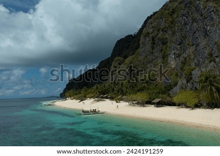 Spectacular aerial view of a tropical beach with a bankga boat, in Black Island, Philippines