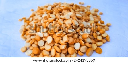 The picture depicts Bengal gram lentils, also known as chana dal or split chickpeas.Bengal gram lentils are yellowish-orange in color and have a mild, nutty flavor. They are a rich source of protein.