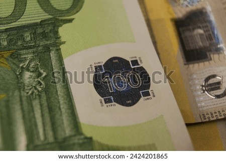 A fragment of a 100 euro banknote with a hologram. High quality photo