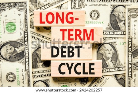 Long-term debt cycle symbol. Concept words Long-term debt cycle on beautiful wooden block. Beautiful dollar bills background. Dollar bills. Business Long-term debt cycle concept. Copy space