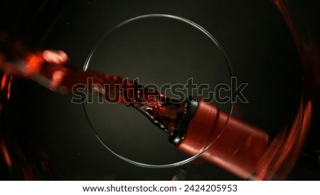 Pouring Red Wine into Glass, Macro Shot. Unique Composition Shot from Inside of the Glass.