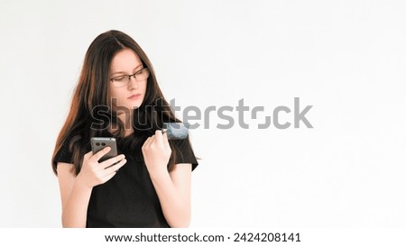 Bank fraud. Online payment. Woman using phone CVV code credit card information for electronic transfer isolated on white empty space background. Royalty-Free Stock Photo #2424208141