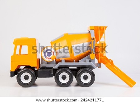 Concrete truck. Multi-colored children's toys plastic trucks on a white background.