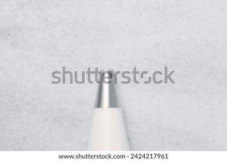 Buttercream in a piping bag with piping nozzle tip, American buttercream in a piping bag for icing cake, frosting for decorating cake
