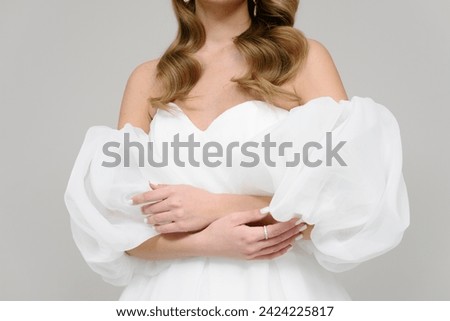 young bride in wedding dress, hands on wrist, cropped, unrecognizable, no face, background