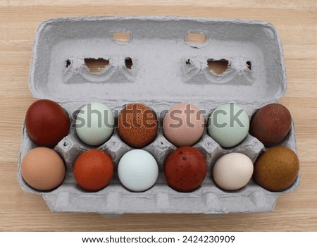 A Dozen Colorful Natural Chicken Eggs  Royalty-Free Stock Photo #2424230909