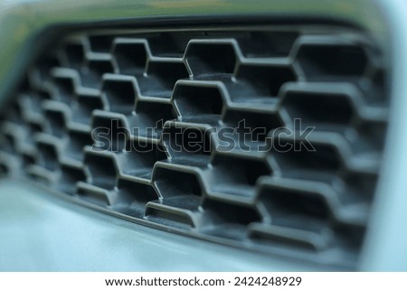 aero filter in front of car with  a bee house design and little risk for maintenance Royalty-Free Stock Photo #2424248929
