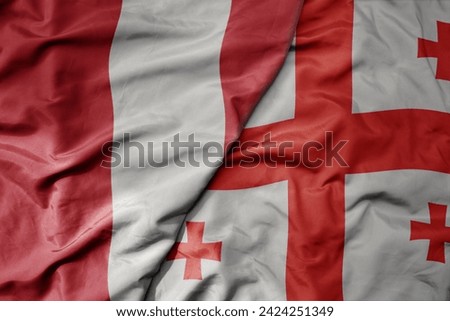 big waving national colorful flag of georgia and national flag of peru . macro