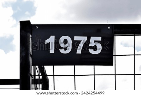 Street sign number 1975 on a black grid